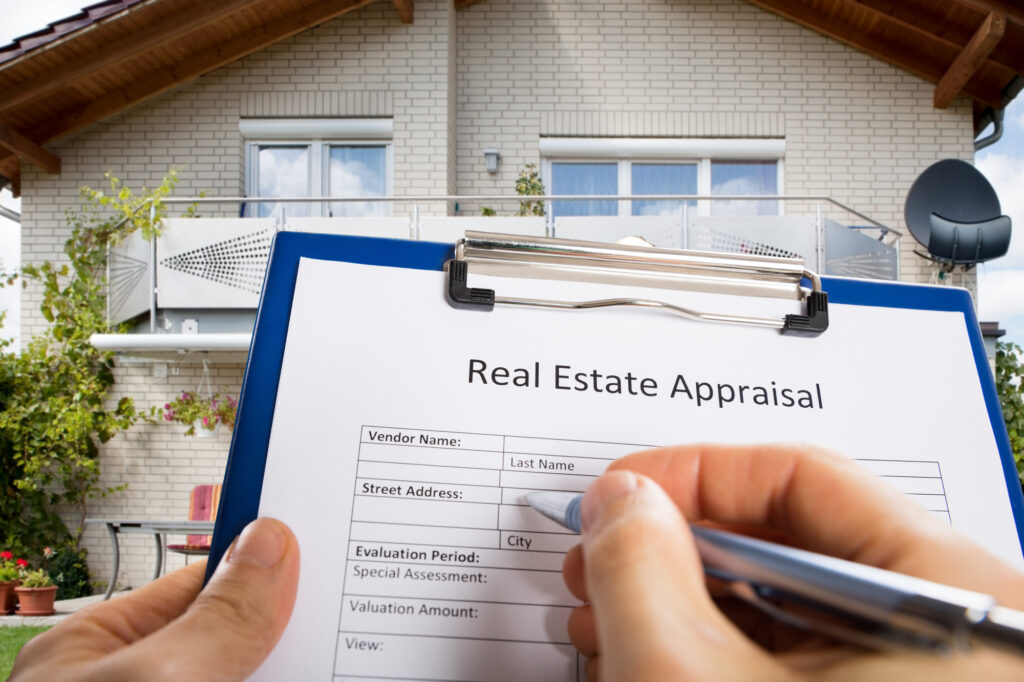 Close-Up of Person Completing a Real Estate Appraisal Document